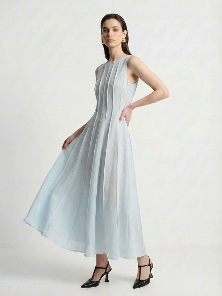 Woman wearing a light blue dress on a white background